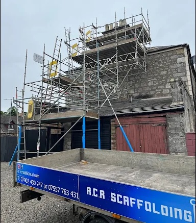 The RCR Scaffolding Solutions team with branded vehicles, a family-run scaffolding company serving Stirling and Central Scotland for 40 years.