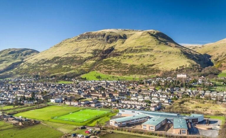 Specialist multi-storey scaffolding erected by RCR Scaffolding Solutions on a traditional stone villa in Alva, FK12, providing safe access at the foot of the Ochil Hills with 40 years of family-run experience.