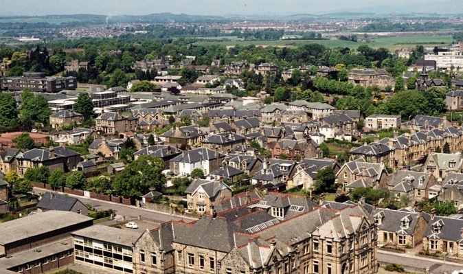 Large multi-level commercial scaffolding tower erected by RCR Scaffolding Solutions on a prominent stone building in Falkirk town center, FK1, near the Steeple, providing safe access with 40 years of local experience and CISRS qualified safety.